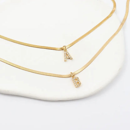 Collana a spina di pesce Melly® con iniziale e zirconi (Set)